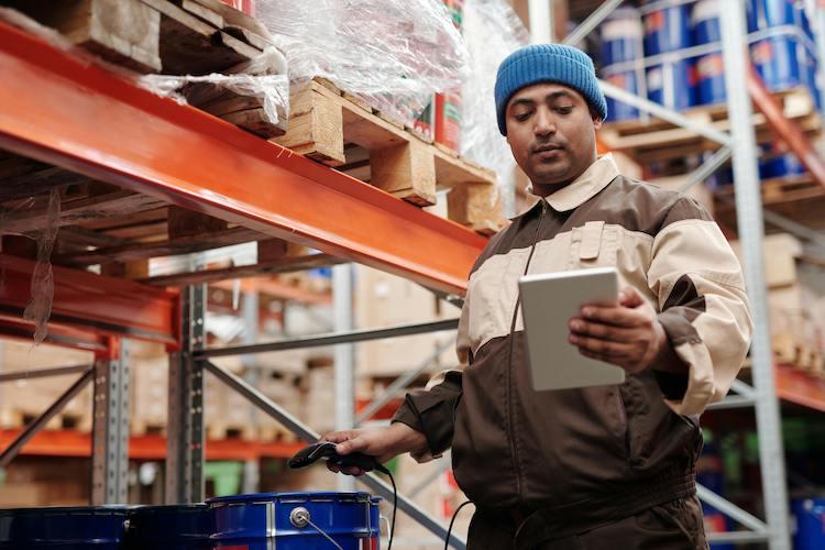 Fiber Internet - Man checking warehouse order on tablet computer