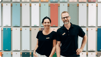 Fiber Internet - Male and female employee standing in front of paint samples