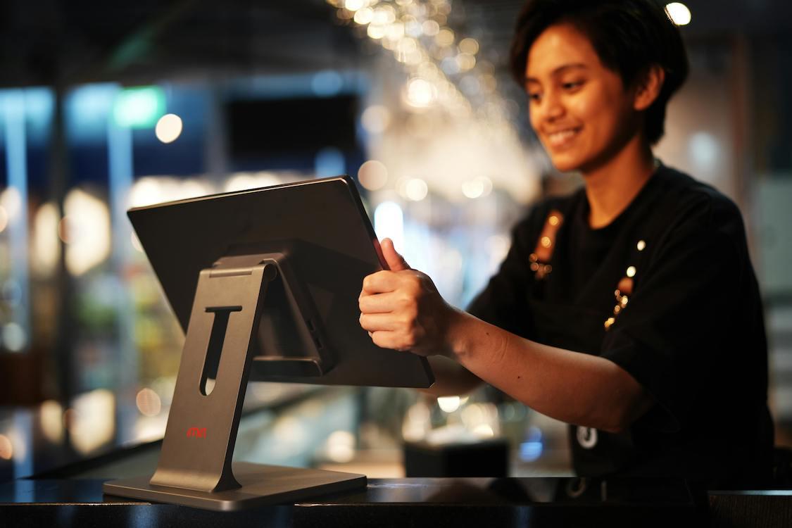 Female cashier ringing up purchase at a restaurant